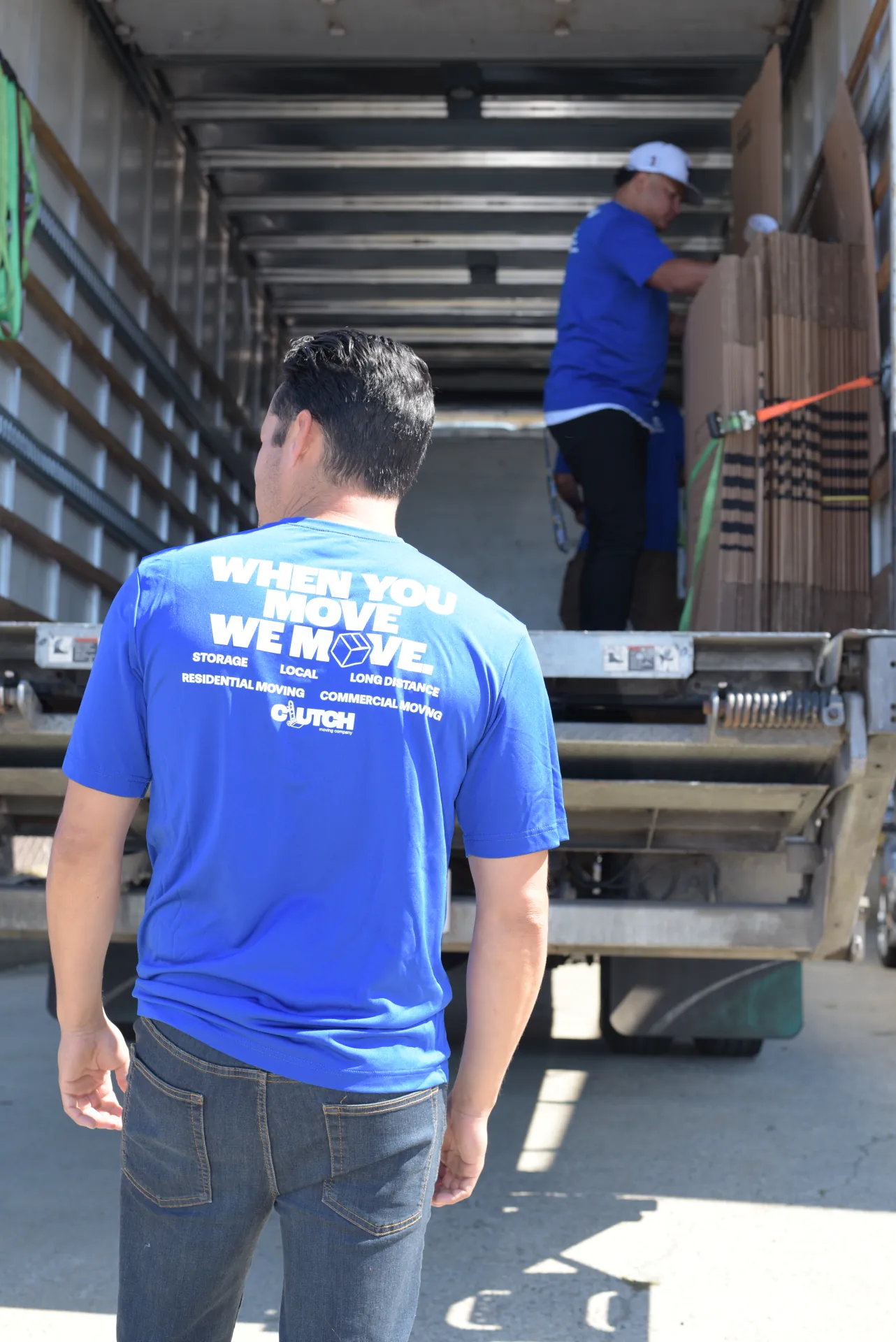Clutch mover in a When You Move, We Move shirt loading a truck
