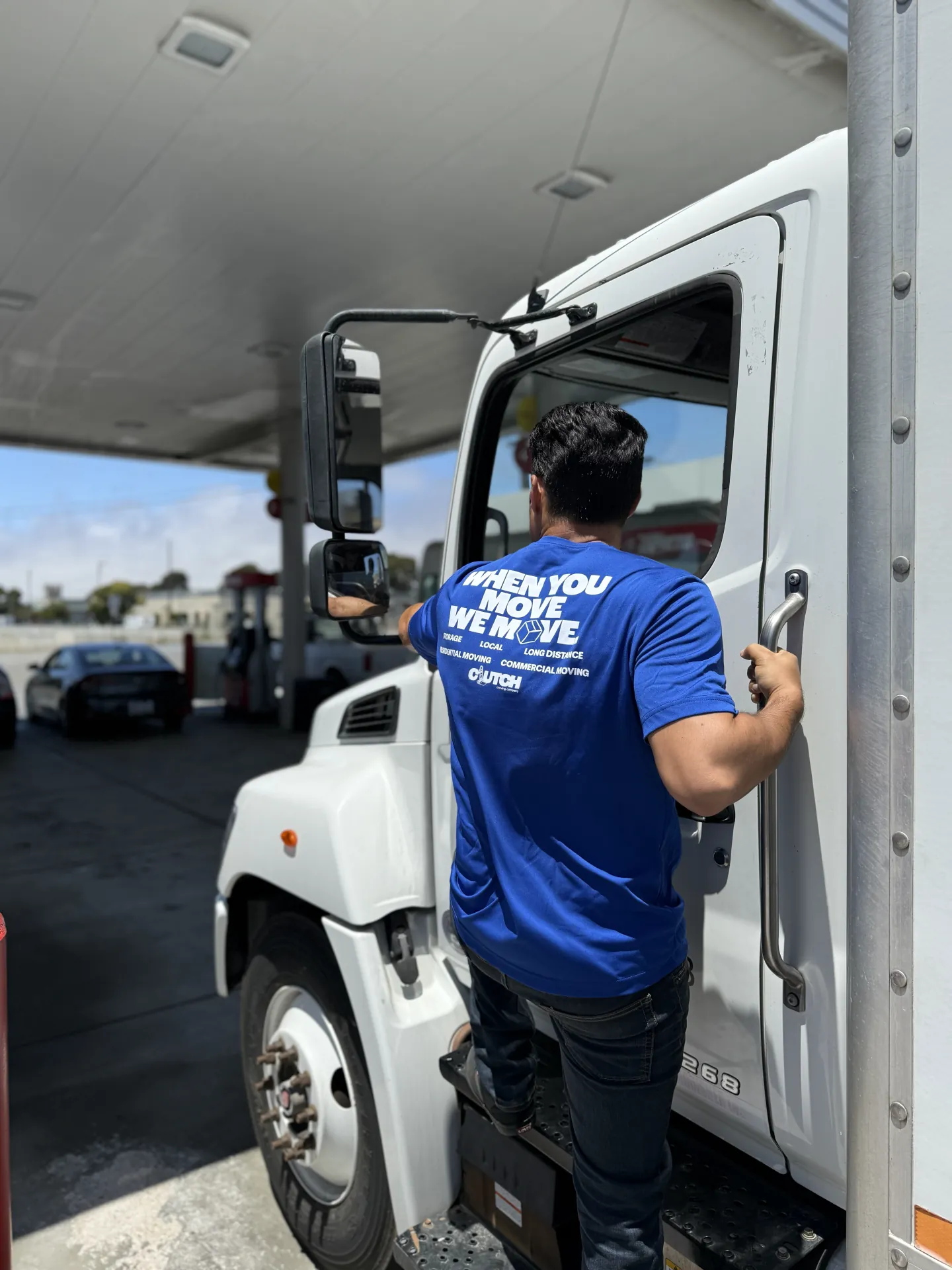 Clutch mover climbing into the cab of a moving truck