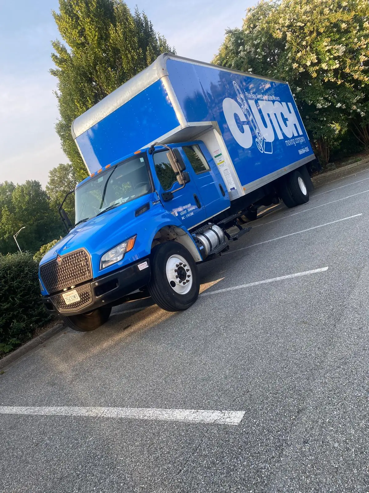 Blue Clutch Moving Company box truck in a parking lot