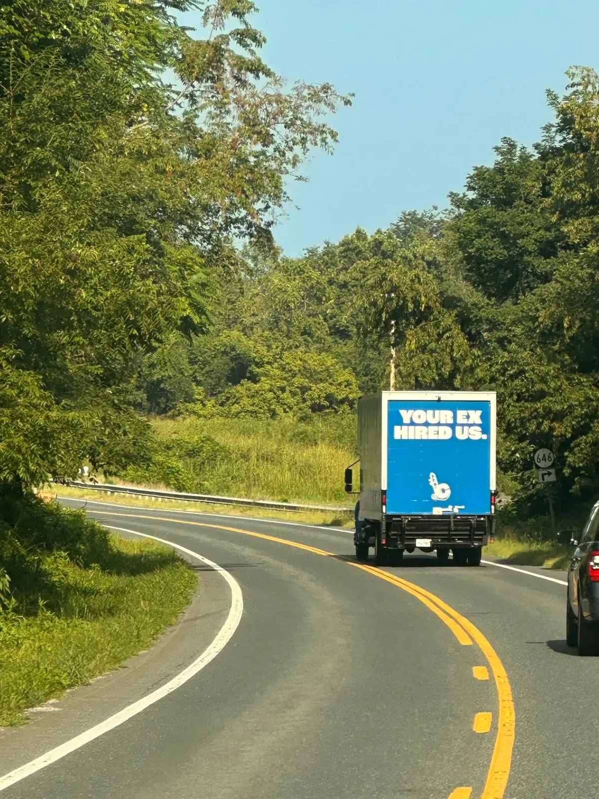 Clutch Moving Company truck on a winding road