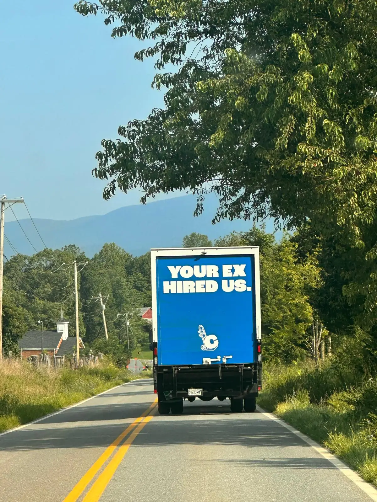 Clutch Moving Company truck driving on a country road